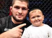 Hasbulla Magomedov and legendary pro MMA fighter Khabib Nurmagomedov celebrate in the Octagon after a UFC 267 event in the UAE in 2021.