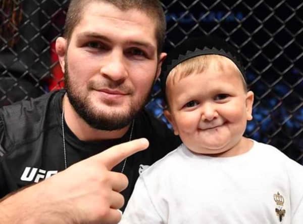 Hasbulla Magomedov and legendary pro MMA fighter Khabib Nurmagomedov celebrate in the Octagon after a UFC 267 event in the UAE in 2021.