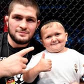 Hasbulla Magomedov and legendary pro MMA fighter Khabib Nurmagomedov celebrate in the Octagon after a UFC 267 event in the UAE in 2021.