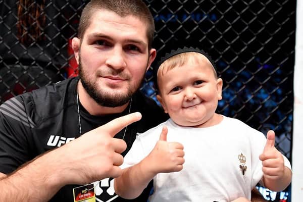 Hasbulla Magomedov and legendary pro MMA fighter Khabib Nurmagomedov celebrate in the Octagon after a UFC 267 event in the UAE in 2021.