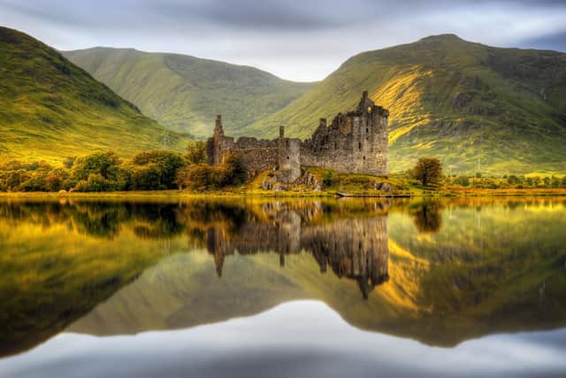 Kilchurn Castle reflections in Loch Awe at sunset, Scotland but people who deferred a holiday in Scotland last spring may still not be able to travel this year.