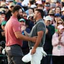 Jon Rahm and Brooks Koepka share a nice moment on the 18th green after playing togethet in the final round of the 2023 Masters. Picture: Christian Petersen/Getty Images.
