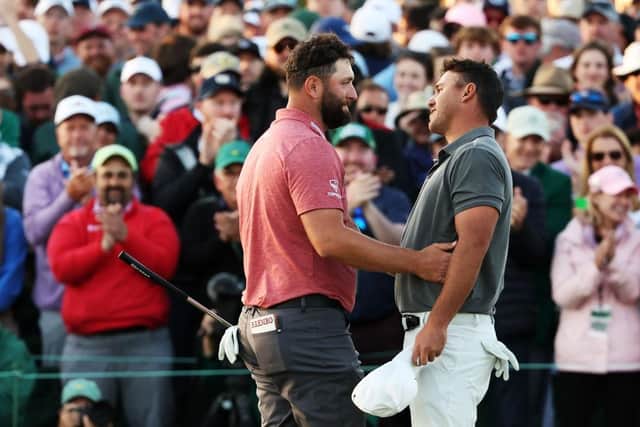 Jon Rahm and Brooks Koepka share a nice moment on the 18th green after playing togethet in the final round of the 2023 Masters. Picture: Christian Petersen/Getty Images.