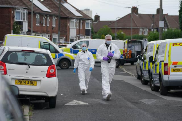 Forensic officers near to the scene in Kingsheath Avenue, Knotty Ash