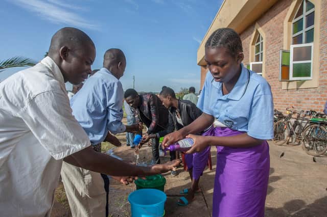People wash their hands as a preventive measure against the Covid-19 coronavirus on the last day of full gatherings at Saint Don Bosco Catholic Parish Church in Lilongwe, Malawi, in March (Picture: Amos Gumulira/AFP via Getty Images)