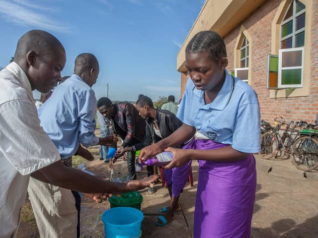 People wash their hands as a preventive measure against the Covid-19 coronavirus on the last day of full gatherings at Saint Don Bosco Catholic Parish Church in Lilongwe, Malawi, in March (Picture: Amos Gumulira/AFP via Getty Images)