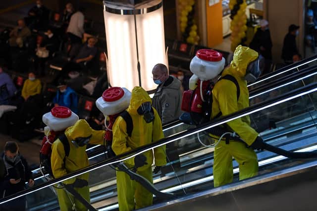 Servicemen of Russia's Emergencies Ministry wearing protective gear disinfects Moscow's Yaroslavsky railway station on October 15, 2020, amid the COVID-19 coronavirus pandemic. Picture: Kirill Kudryavtsev/AFP via Getty Images