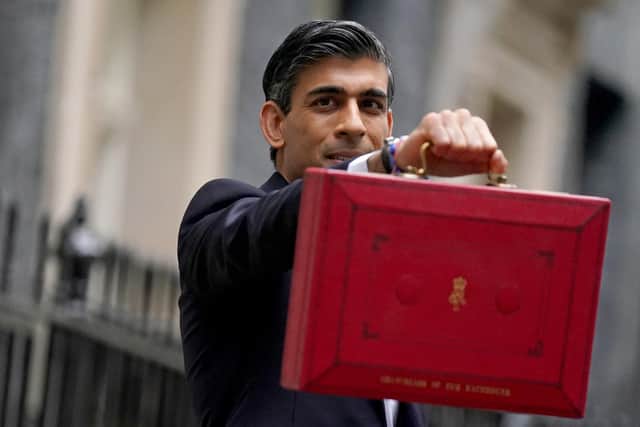 Chancellor of the Exchequer Rishi Sunak holds his ministerial 'Red Box' as he stands with his ministerial team and Parliamentary Private Secretaries, outside 11 Downing Street, London, before delivering his Budget to the House of Commons. Picture date: Wednesday October 27, 2021.