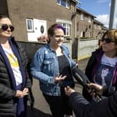 Lyra McKee's partner Sara Canning (centre) with Lyra's sisters Joan Hunter (left) and Nichola Corner during an interview after friends and family laid wreaths at the spot where Lyra McKee was shot three years ago on Fanad Drive in Derry.