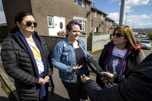 Lyra McKee's partner Sara Canning (centre) with Lyra's sisters Joan Hunter (left) and Nichola Corner during an interview after friends and family laid wreaths at the spot where Lyra McKee was shot three years ago on Fanad Drive in Derry.