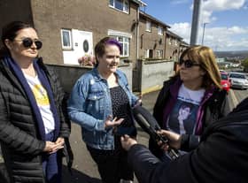 Lyra McKee's partner Sara Canning (centre) with Lyra's sisters Joan Hunter (left) and Nichola Corner during an interview after friends and family laid wreaths at the spot where Lyra McKee was shot three years ago on Fanad Drive in Derry.