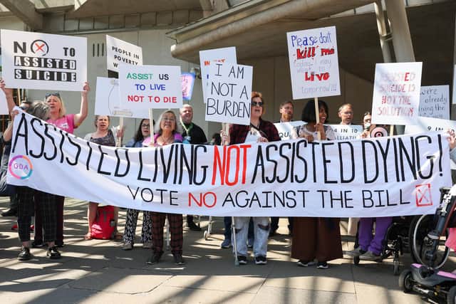 Opponents of plans to legalise assisted dying demonstrate outside the Scottish Parliament (Picture: Jeff J Mitchell/Getty Images)