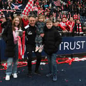 Hamilton manager John Rankin celebrates the SPFL Trust Trophy win with his family.