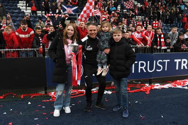 Hamilton manager John Rankin celebrates the SPFL Trust Trophy win with his family.