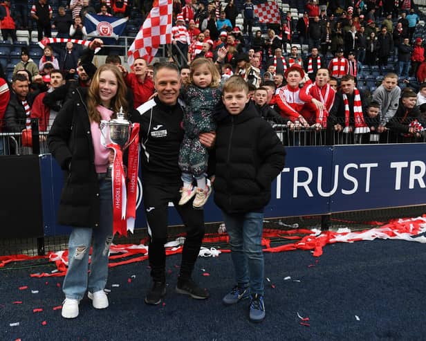 Hamilton manager John Rankin celebrates the SPFL Trust Trophy win with his family.