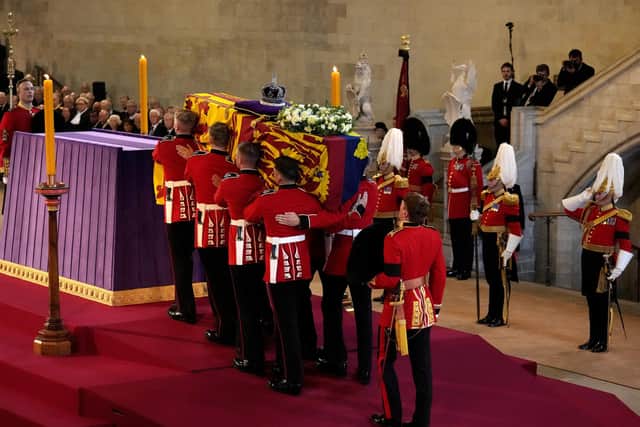 The Coffin of Queen Elizabeth II is carried into The Palace of Westminster during the procession for the Lying-in State of Queen Elizabeth II in London