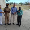 Carol Anderson (left) hands over chanters to the Barbados Defence Force Band, with hopes to set up a pipe band with young army cadets. PIC: Contributed.