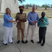 Carol Anderson (left) hands over chanters to the Barbados Defence Force Band, with hopes to set up a pipe band with young army cadets. PIC: Contributed.