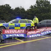 Police officers break up an Insulate Britain protest occupying a roundabout leading from the M25 motorway to Heathrow Airport (Picture: Steve Parsons/PA)