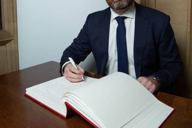 Gregor Poynton MP signs the Holocaust Educational Trust Book of Commitment in the Houses of Parliament.
