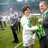 Celtic's Kyogo Furuhashi and Ange Postecoglou with the Premiership trophy at full time.