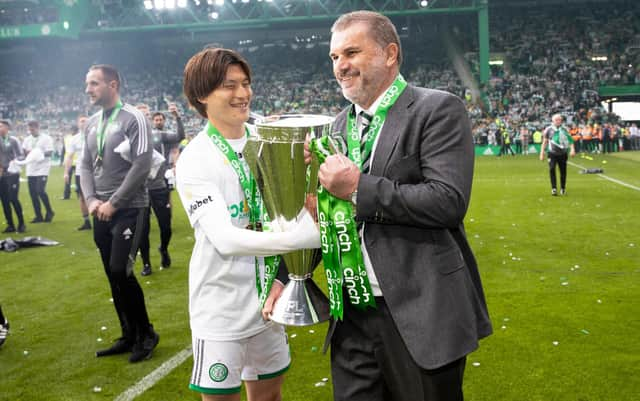 Celtic's Kyogo Furuhashi and Ange Postecoglou with the Premiership trophy at full time.