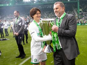 Celtic's Kyogo Furuhashi and Ange Postecoglou with the Premiership trophy at full time.