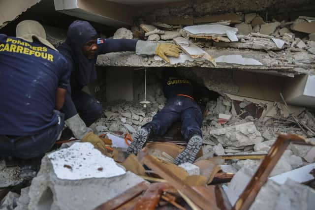 Hunt goes on for Haiti earthquake survivors as storm brings fresh danger