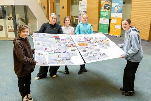 Sarah Chew, TechFest Director, with STEM on the Farm Participants presenting their display board