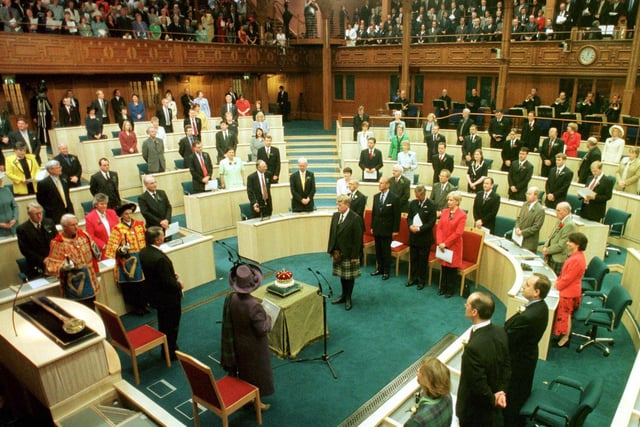 Her Majesty The Queen accompanied by the Royal Party look on as the 15th Duke of Hamilton presents the Crown of Scotland to the Chamber during the Opening of The Scottish Parliament in Edinburgh on 1 July 1999.