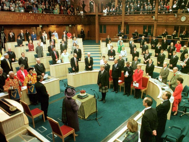 Her Majesty The Queen accompanied by the Royal Party look on as the 15th Duke of Hamilton presents the Crown of Scotland to the Chamber during the Opening of The Scottish Parliament in Edinburgh on 1 July 1999.