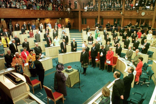 Her Majesty The Queen accompanied by the Royal Party look on as the 15th Duke of Hamilton presents the Crown of Scotland to the Chamber during the Opening of The Scottish Parliament in Edinburgh on 1 July 1999.
