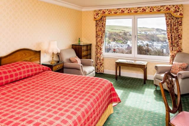 A double bedroom with views of the harbour and sea.