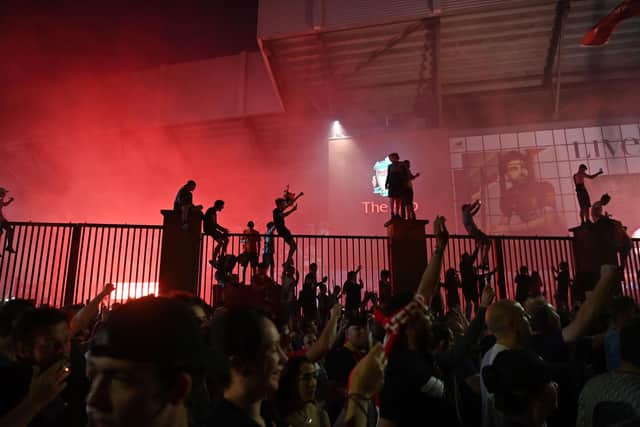 Fans celebrate Liverpool winning the Premier League title outside Anfield.