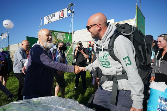 Michael Eavis (left) shakes hands with a festivalgoer at the Glastonbury Festival at Worthy Farm in Somerset.  Glastonbury festival organiser Emily Eavis marked the opening of the gates with a post on Instagram, writing alongside a picture: “Gates are OPEN… Welcome everyone to Glastonbury 2022!”.