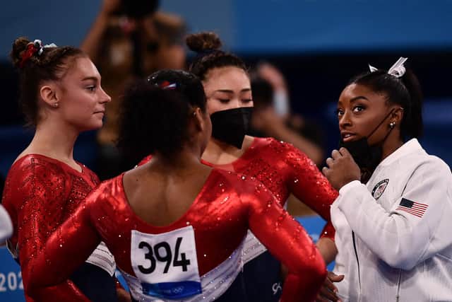 Simone Biles, right, speaks with her USA teammates. Picture: AFP via Getty Images