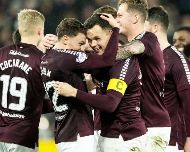 Aidan Denholm embraces Lawrence Shankland after the striker continued his rich vein of Hearts form against St Mirren.