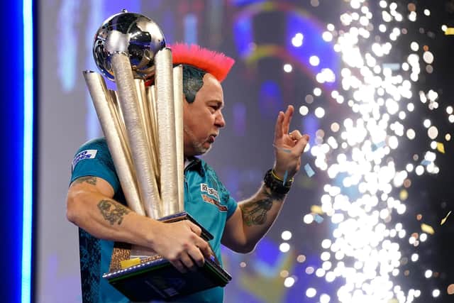 Peter Wright with the Sid Waddell Trophy after victory against Michael Smith during day sixteen of the William Hill World Darts Championship at Alexandra Palace, London. (John Walton/PA Wire).