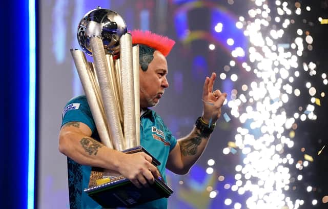 Peter Wright with the Sid Waddell Trophy after victory against Michael Smith during day sixteen of the William Hill World Darts Championship at Alexandra Palace, London. (John Walton/PA Wire).