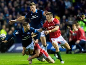 Scotland's Finn Russell offloads the ball for a Kyle Steyn try as Huw Jones watches on during the 35-7 win over Wales. (Photo by Ross Parker / SNS Group)