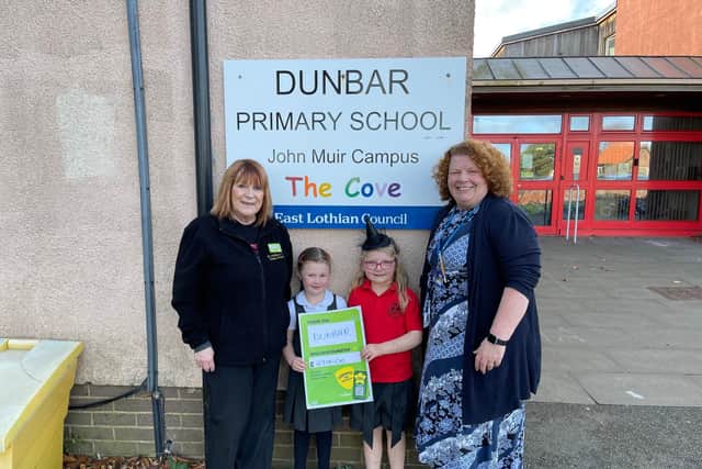 Asda Dunbar Community Champion Annette Newell with Jacqui Mackinnon, Head teacher and pupils of Dunbar PS