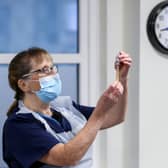 Practice Nurse Ruth Davies holds a vial of the Oxford/AstraZeneca coronavirus vaccine at Pentlands Medical Centre in Edinburgh.