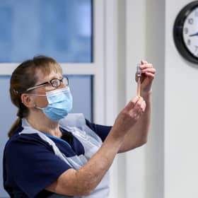 Practice Nurse Ruth Davies holds a vial of the Oxford/AstraZeneca coronavirus vaccine at Pentlands Medical Centre in Edinburgh.
