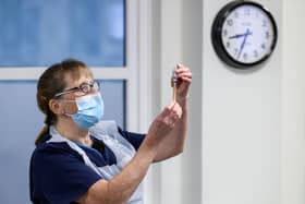 Practice Nurse Ruth Davies holds a vial of the Oxford/AstraZeneca coronavirus vaccine at Pentlands Medical Centre in Edinburgh.