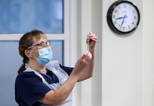 Practice Nurse Ruth Davies holds a vial of the Oxford/AstraZeneca coronavirus vaccine at Pentlands Medical Centre in Edinburgh.
