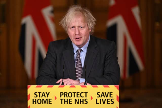 Prime Minister Boris Johnson speaks during a televised press conference at 10 Downing Street on February 22, 2021