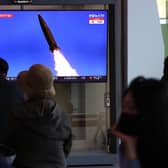 People watch a TV news program reporting on North Korea test-firing a newly developed tactical guided weapon, at Seoul train station on April 17, 2022 in Seoul, South Korea. North Korea has test-fired a new weapons system which it claims will boost the efficiency of its tactical nuclear weapons, state media has reported. (Photo by Chung Sung-Jun/Getty Images)