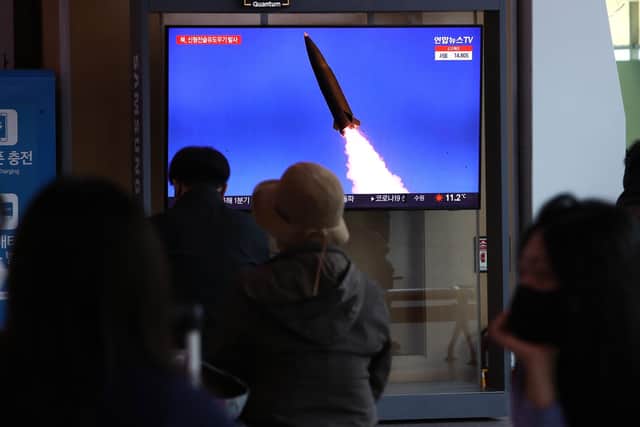 People watch a TV news program reporting on North Korea test-firing a newly developed tactical guided weapon, at Seoul train station on April 17, 2022 in Seoul, South Korea. North Korea has test-fired a new weapons system which it claims will boost the efficiency of its tactical nuclear weapons, state media has reported. (Photo by Chung Sung-Jun/Getty Images)