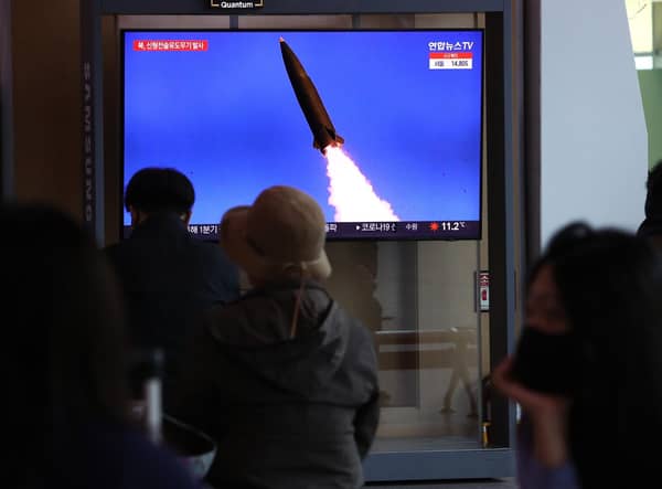 People watch a TV news program reporting on North Korea test-firing a newly developed tactical guided weapon, at Seoul train station on April 17, 2022 in Seoul, South Korea. North Korea has test-fired a new weapons system which it claims will boost the efficiency of its tactical nuclear weapons, state media has reported. (Photo by Chung Sung-Jun/Getty Images)
