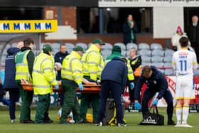 Dundee's Michael Mellon is forced off with a head injury during the match against St Johnstone.
